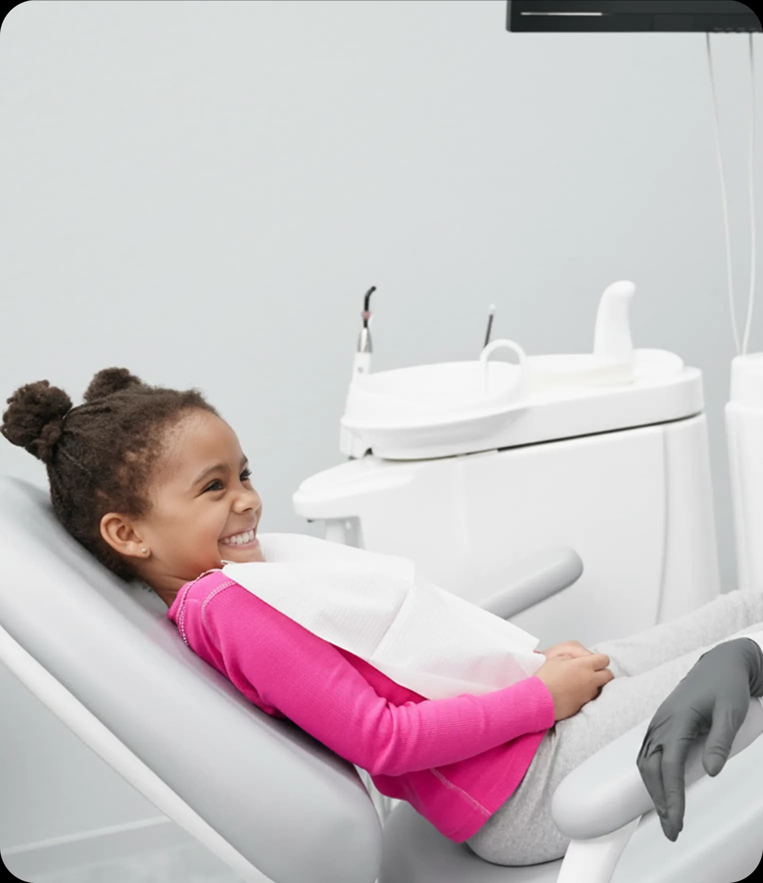 Child patient smiling in dental chair