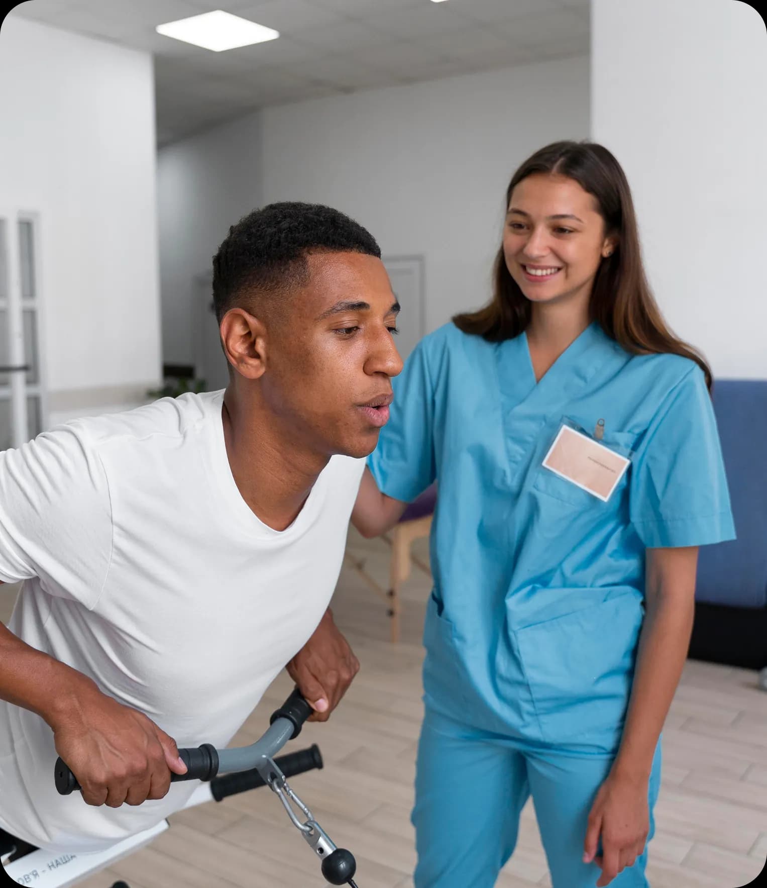 Patient on exercise bike with physiotherapist